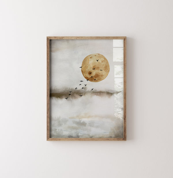 A watercolor painting depicting a large, full moon with a muted yellow hue. A flock of black birds flies across the moon's face, creating a dramatic contrast. The background is a soft, muted grey with subtle hints of blue and green. The picture is hung on a white wall.