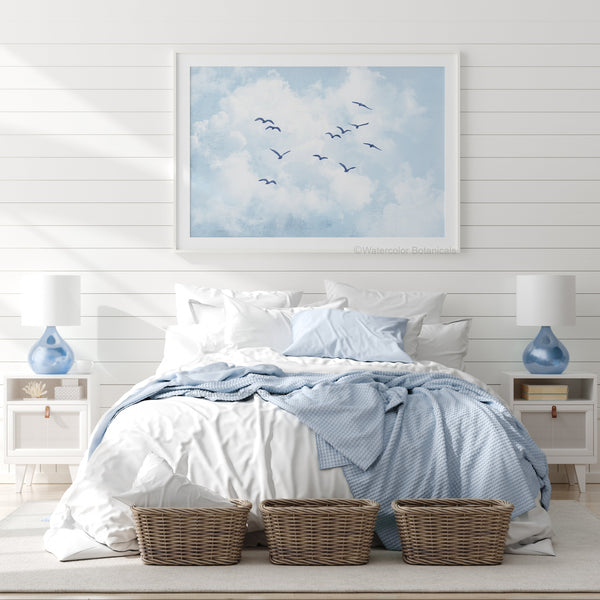 Bedroom with a large framed artwork of birds flying in the sky above the bed.