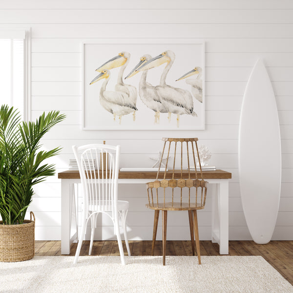 white abstract pelicans on white background hang above a desk in modern coastal room