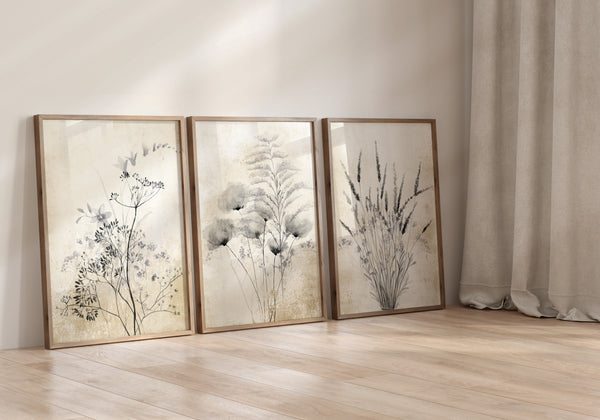 Three framed prints showcasing delicate botanical designs in muted colors, creating a calming and elegant atmosphere on a white wall.