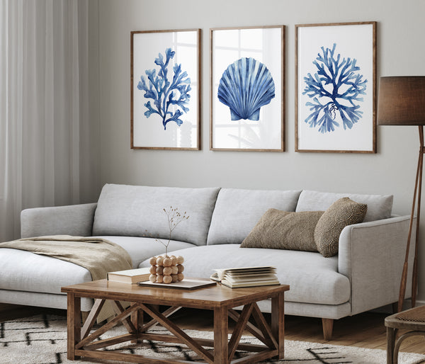 Living room with a gray sofa, wooden coffee table, and wall art of blue shells and coral.