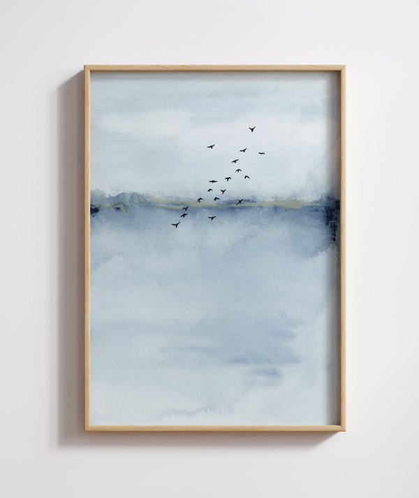 A framed Blue Watercolor Abstract painting of a blue and white landscape with a flock of birds flying across the sky.