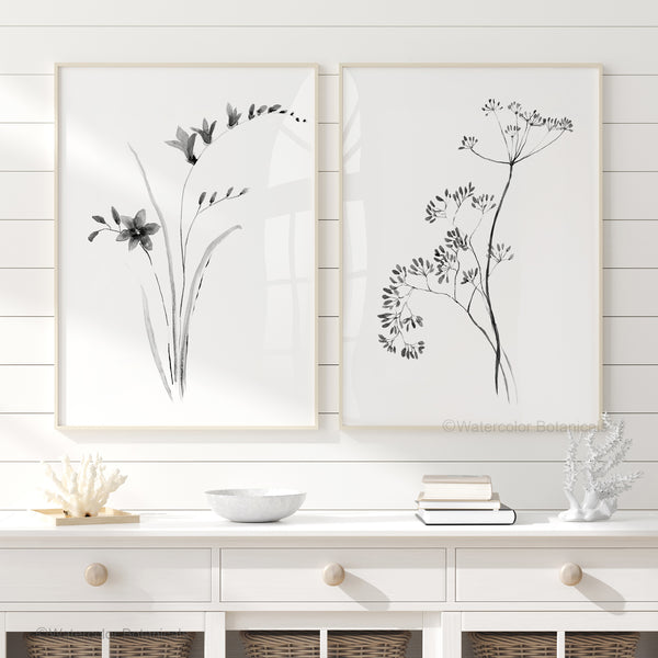 Set aus zwei minimalistischen botanischen Wandkunst-Drucken in Schwarz.