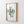 A framed watercolor painting captures the intricate beauty of a single type of green coral, adding a touch of nature to a white wall.