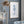 Framed seahorse art print on a dusty blue wall beside a glass cabinet