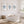 Bathroom with a freestanding bathtub, starfish, coral, and fish artwork on the wall.