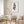 Slender brown eucalyptus print above a round dining table