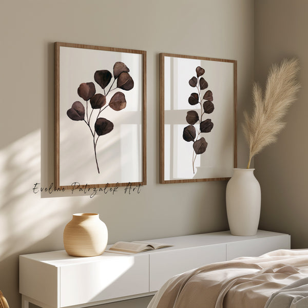 Close view of two chocolate brown eucalyptus watercolor prints in light wood frames