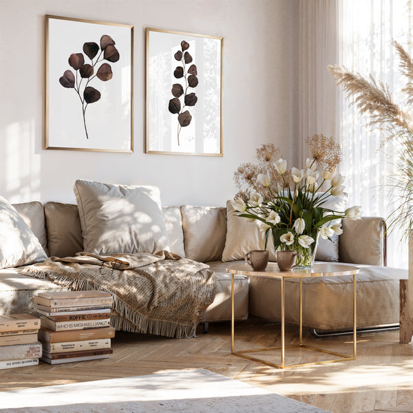 Brown botanical prints set of 2 above a beige sofa in a bright living room