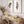 Brown watercolor eucalyptus prints above a rustic wooden console table