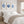 Bedroom with a bed, white bedding, and blue coral art on the wall.