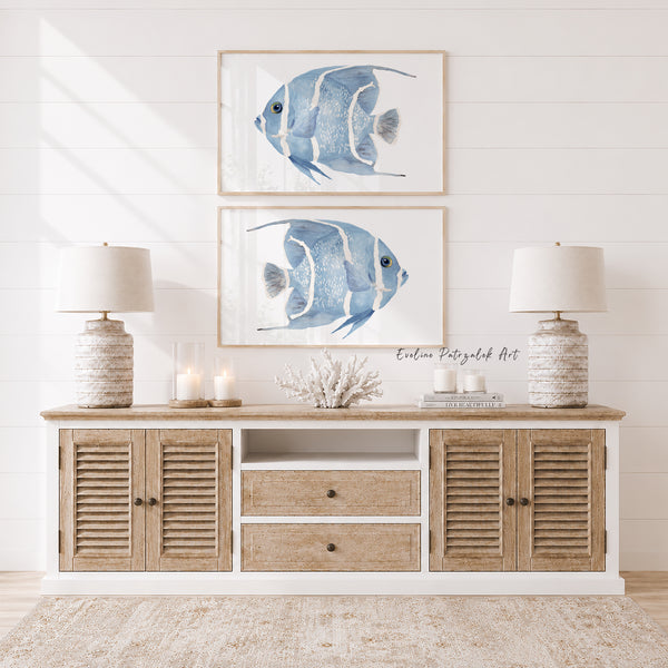 Living room with wooden console table, lamps, and framed blue striped fish art on the wall.