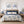 Bedroom with floral bedding, blue lamps, and blue minimalist wall art in 2 frames