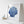 Framed artwork of a blue shell on a white surface with a small boat model.