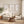 Set of 3 minimalist brown branch prints in oak frames above a linen sofa and jute rug