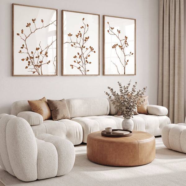 Tan and cognac wall art set of 3 in a cream living room with boucle sofa