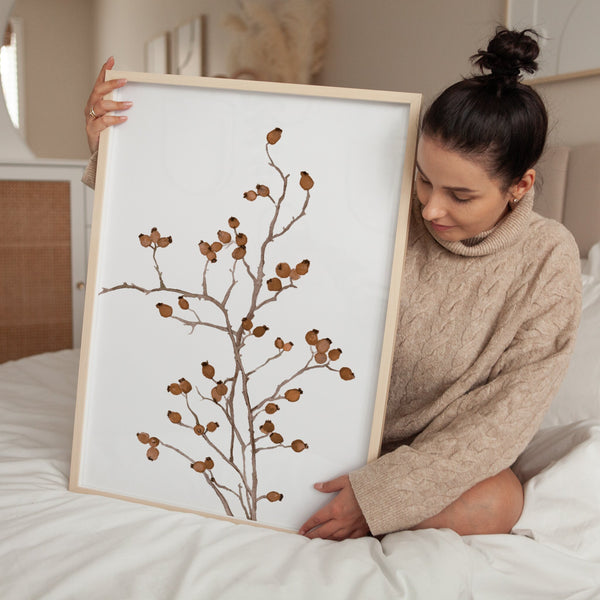 Woman holding a large framed brown berry branch print