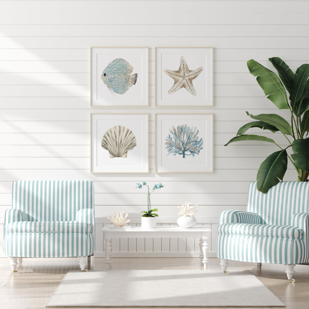 Living room with striped armchairs, a coffee table, and framed coastal art on a white wall.