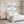 Blue discus fish watercolor wall art set of two displayed above a bed in a bright blue and white coastal bedroom with natural wood frames.