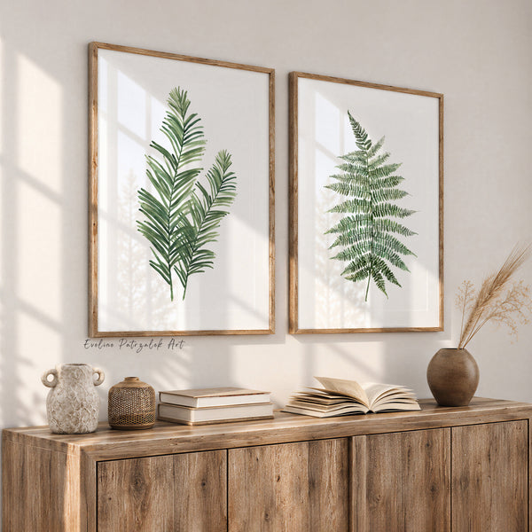 Green fern and palm leaf wall art set of 2, watercolor botanical prints above a rustic wooden sideboard