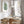 Single green watercolor fern print above a round wooden dining table