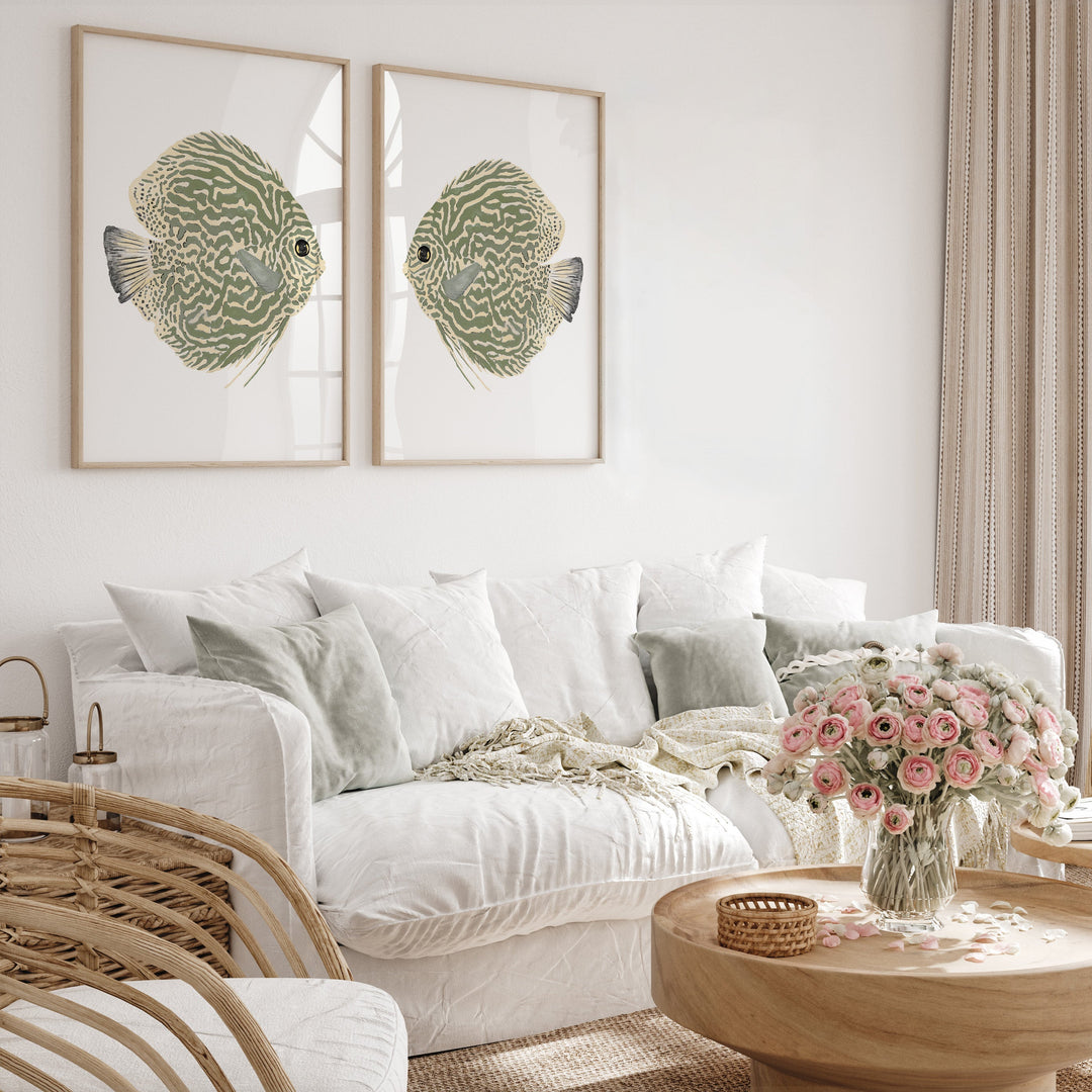 Living room with white sofa, framed fish artwork, and a coffee table with flowers.