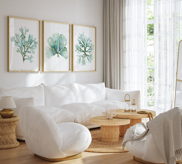 Modern living room with white sofa, armchairs, and decorative wall art.