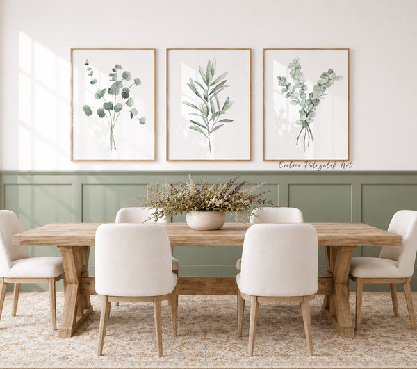 Dining room with wooden table and white chairs, featuring framed botanical prints on the wall.