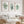 green watercolor corals and seaweed hang in wooden frames above white couch in modern living room