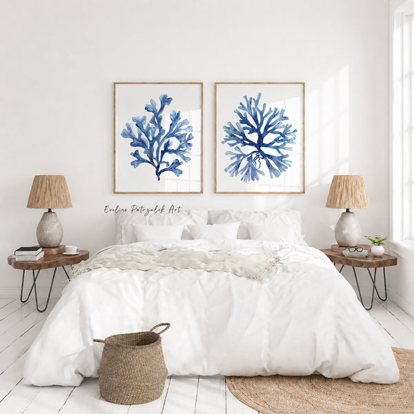 Bedroom with white bedding, wooden nightstands, and blue coral art on the wall.