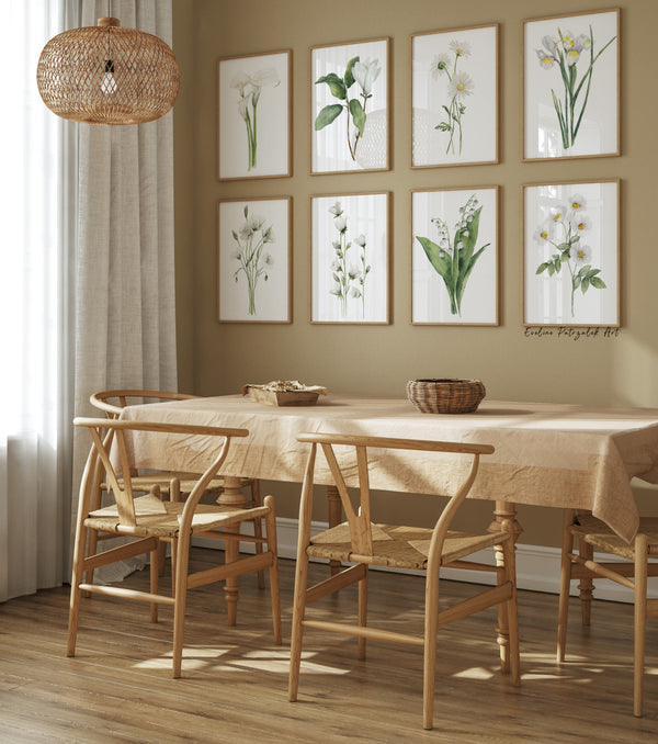 Dining room with wooden table and chairs, 8 frames with minimalist floral prints on the wall.