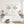 Light green discus fish wall art set of 2 above a white bed between rattan lamps