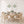 Two light green fish prints above a round wooden dining table