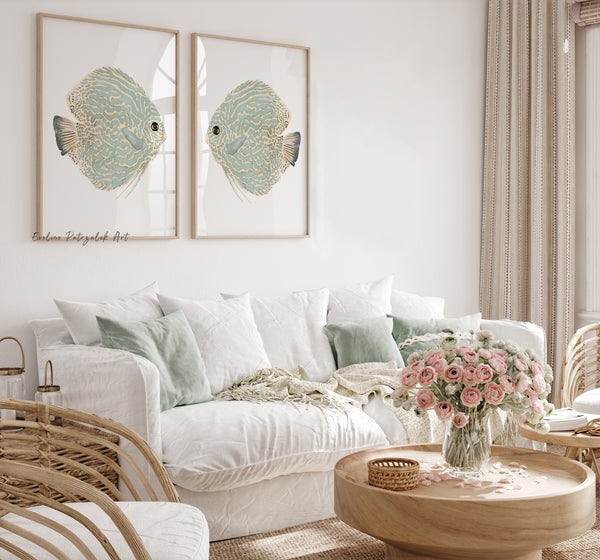 Light green discus fish prints in light wood frames above a white sofa with mint pillows