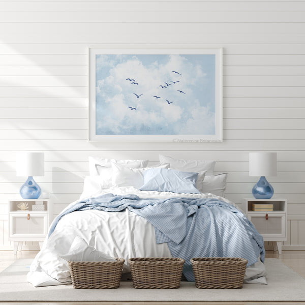 Bedroom with a large framed artwork of birds flying in the sky above the bed.