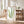Framed artwork of green leaves in a bright room with wooden furniture