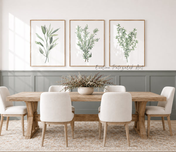 Dining room with wooden table and chairs, framed botanical prints showing minimalist modern kitchen herbs on the wall.