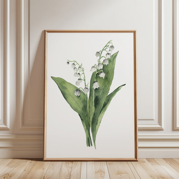 Framed artwork of a floral design on a wall with wooden floor.