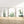 minimalist watercolor cacti set of 3 prints standing in frames on the wooden floor