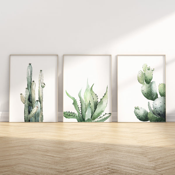 minimalist watercolor cacti set of 3 prints standing in frames on the wooden floor