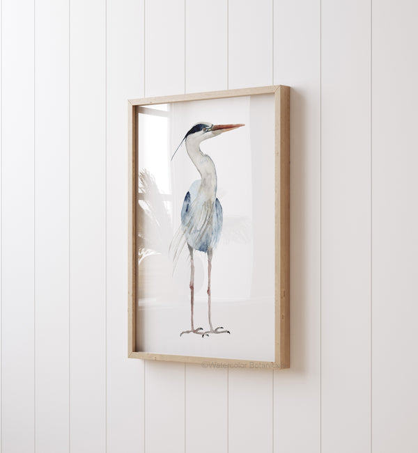 A watercolor painting of a minimalist large heron adds a touch of nature to a room with white paneling and a white wall.