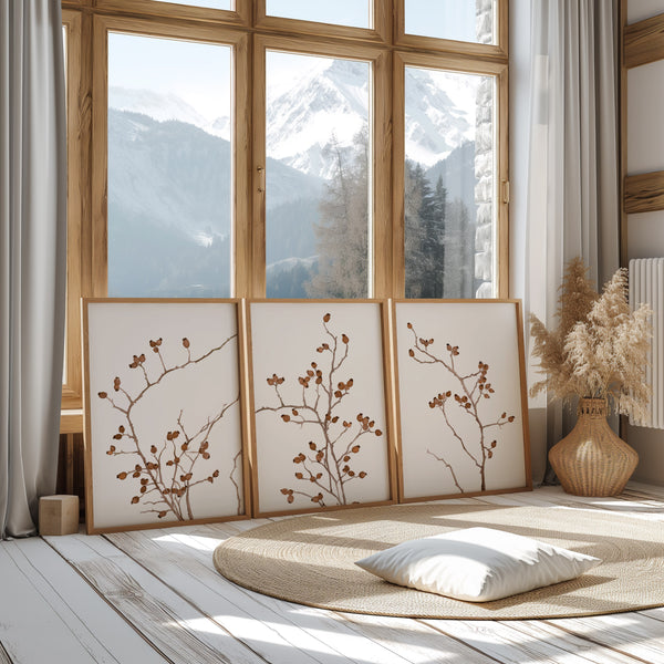 minimalist watercolor rosehips 3 images in wooden frames stand on the floor and lean againts large a window with mountain view