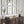 Framed botanical prints on a wall above a wooden console table with decorative items.