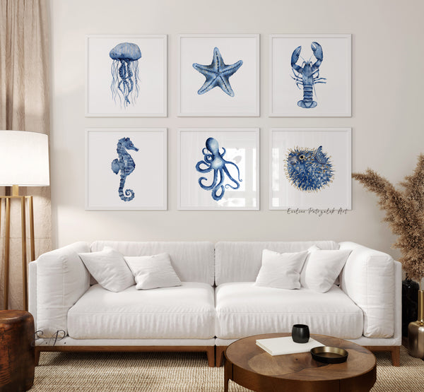 Living room with white sofa and square wall art featuring navy blue sea creatures including minimalist watercolor jellyfish, starfish, lobster, seahorse, octopus and puffer or so called diodon fish.