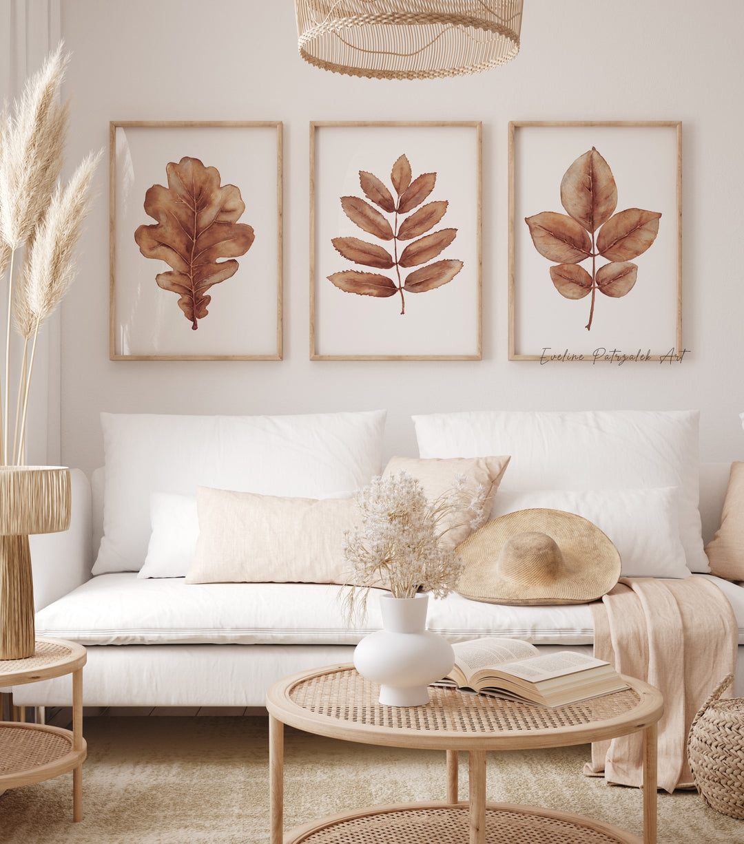 Living room with a white sofa, leaf-themed wall art, and decorative items.