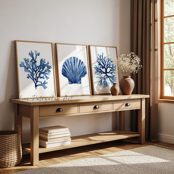 Wooden console table with decorative items including framed artwork witn and a vase.g minimalist navy blue corals and shell in teh middle painted in deep navy blue coloragainst white background