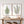 Two framed botanical art prints hang on a white wall above a rustic wooden console table. The left print shows a green fern, and the right print shows green eucalyptus stems, both in light wood frames.