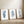 Three navy blue watercolor botanical prints of eucalyptus and leaf branches leaning on a wooden floor