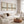 Three neutral abstract landscape prints above a cream boucle sofa and leather pouf