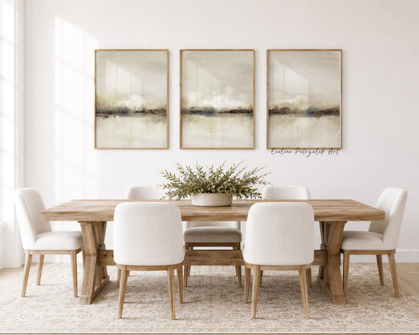 Beige watercolor landscape set of 3 above a wooden dining table with white chairs